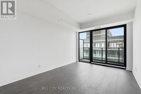 Toronto (Thorncliffe Park) condo for rent - A spacious room with a sliding glass door leading to a balcony.