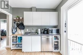 Bradford West Gwillimbury (Bradford) fourplex for rent - A kitchen with white cabinets and a stainless steel sink.