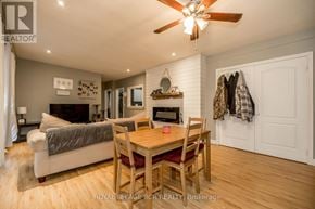 Bradford West Gwillimbury (Bradford) fourplex for rent - A well-lit room with a dining table and chairs, a couch, and a ceiling fan.