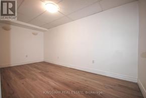 Burlington (Shoreacres) townhouse for rent - Empty room with wooden floor and white walls.