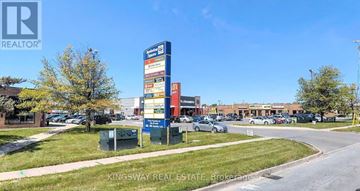 Burlington (Shoreacres) townhouse for rent - A Kingsway Real Estate sign is displayed in front of a building.