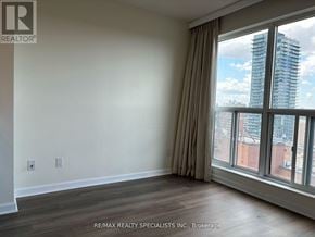 Toronto (Rosedale-Moore Park) condo for rent - A room with a large window overlooking a cityscape.