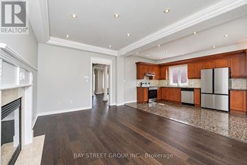 Richmond Hill (Westbrook) apartment for rent - A spacious kitchen with wooden cabinets and a marble floor.