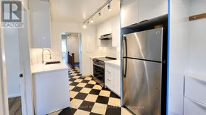 Toronto (Keelesdale-Eglinton West) apartment for rent - A black and white checkered floor in a kitchen with a stainless steel refrigerator.