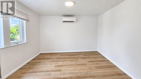 Toronto (Keelesdale-Eglinton West) apartment for rent - A room with wooden flooring and a window with blinds.