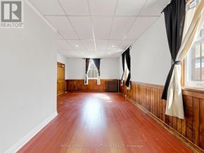 Halton Hills (Georgetown) multi-family for rent - A room with wooden floors and white walls.