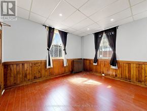 Halton Hills (Georgetown) multi-family for rent - A room with wooden walls and a brown floor.