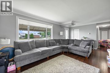 Lakeshore apartment for rent - A living room with a grey sofa set and a rug.