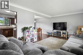 Lakeshore apartment for rent - A living room with grey couches and a television.