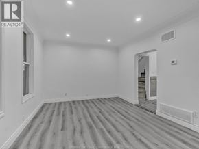 Windsor apartment for rent - A spacious room with wooden flooring and white walls.