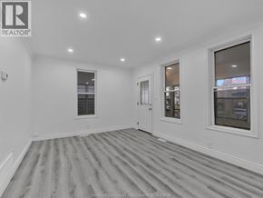 Windsor apartment for rent - A spacious room with wooden flooring and white walls.