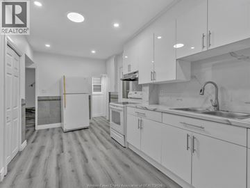 Windsor apartment for rent - A kitchen with white cabinets and appliances.
