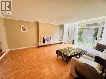 Vancouver apartment for rent - A living room with a brown ottoman and a painting on the wall.