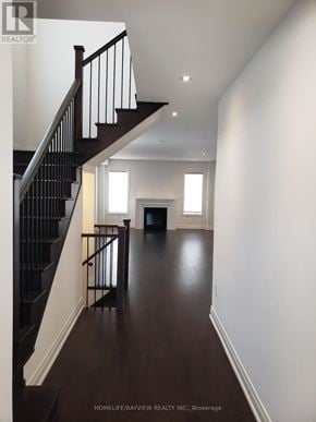 Oakville (Go Glenorchy) apartment for rent - A long hallway with a staircase on the left and a door on the right.