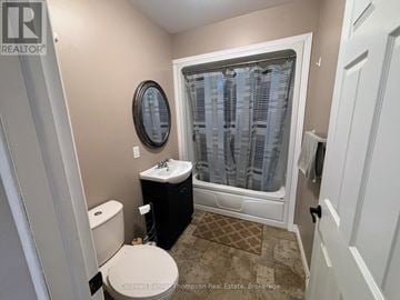 Huntsville (Chaffey) triplex for rent - A kitchen with a black refrigerator and stove.