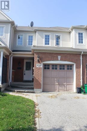 Whitby (Taunton North) townhouse for rent - A house with a brown garage door and a white door.