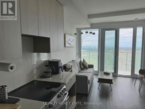 Mississauga (City Centre) condo for rent - A modern kitchen with a stove top oven and a dining table with chairs.
