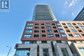 Toronto (Thorncliffe Park) condo for rent - A tall building with a glass facade and a sign that reads "Big City Realty, Inc., Brokerage.".