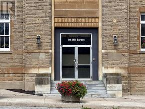 Halton Hills (Georgetown) multi-family for rent - A stone building with a blue door and a window with flowers in front.