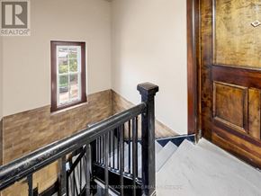Halton Hills (Georgetown) multi-family for rent - A staircase with a black railing and a window on the wall.