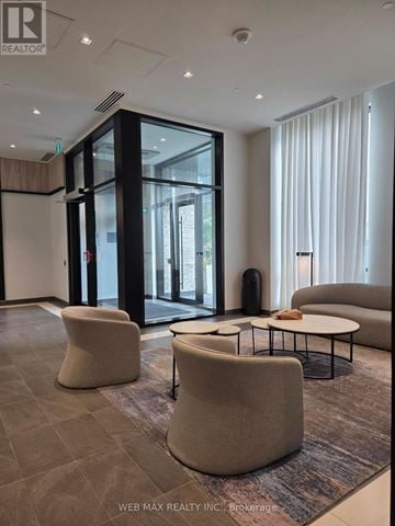 Hamilton (Beasley) condo for rent - A living room with a grey carpet and a white sofa.
