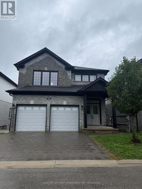 London South (South U) house for rent - A house with a grey roof and two garage doors.