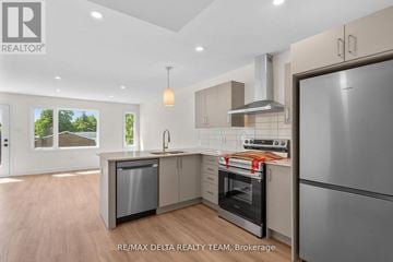 Ottawa apartment for rent - A modern kitchen with a refrigerator, oven, and sink.
