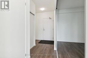 Richmond Hill condo for rent - A brokerage image of a white hallway with a door and a mat on the floor.