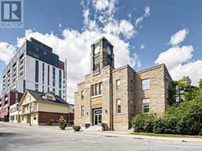 Halton Hills (Georgetown) multi-family for rent - A building with a clock tower stands in front of a modern building.