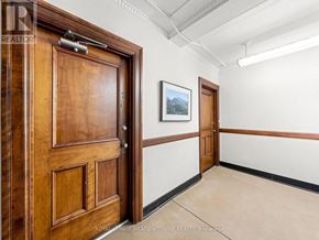 Halton Hills (Georgetown) multi-family for rent - A room with a brown door and a painting on the wall.