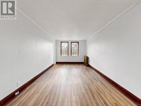 Halton Hills (Georgetown) multi-family for rent - A room with wooden floors and white walls.