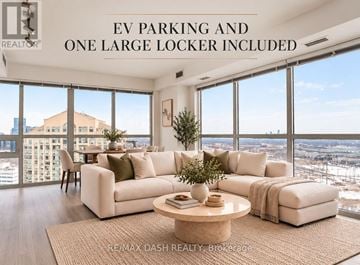 Toronto (Islington-City Centre West) condo for rent - A living room with a large window overlooking a cityscape.