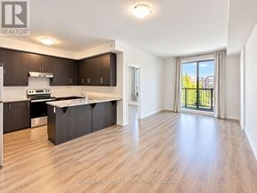 Toronto (West Humber-Clairville) townhouse for rent - A spacious kitchen with dark brown cabinets and a white countertop.