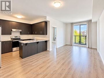 Toronto (West Humber-Clairville) townhouse for rent - A spacious kitchen with dark brown cabinets and a white countertop.