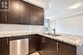 Toronto (West Humber-Clairville) townhouse for rent - A kitchen with brown cabinets and a marble countertop.