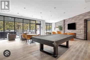 Kitchener condo for rent - A modern dining room with a large table and chairs.