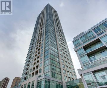 Toronto (North St. James Town) condo for rent - A tall building with many windows is the focal point of the image.