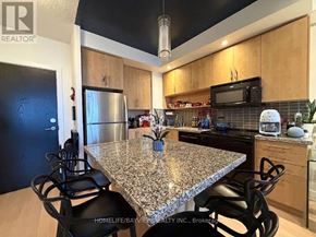 Toronto (North St. James Town) condo for rent - A kitchen with granite countertops and stainless steel appliances.