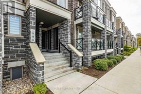 Markham (Cornell) townhouse for rent - A row of townhouses with stone exteriors and steps leading to the doors.