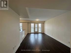 Markham (Cornell) townhouse for rent - A spacious room with wooden floors and a window with blinds.