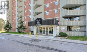London South (South X) condo for rent - A building with a sign that says "Village Pines".
