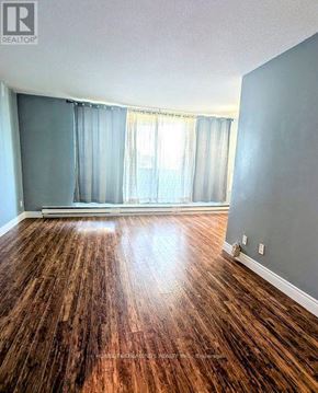 London South (South X) condo for rent - A room with wooden flooring and a window with curtains.