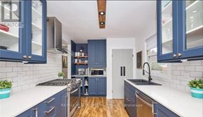 St. Catharines (Carlton/Bunting) apartment for rent - A kitchen with blue cabinets and a white countertop.