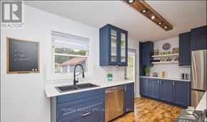 St. Catharines (Carlton/Bunting) apartment for rent - A kitchen with dark blue cabinets and a white countertop.