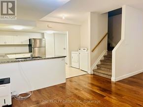 Ottawa townhouse for rent - A kitchen with white cabinets and a stainless steel refrigerator.