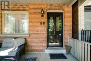 Toronto (Woodbine Corridor) apartment for rent - A house number 88 with a black door and a white chair.