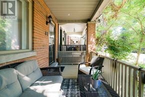 Toronto (Woodbine Corridor) apartment for rent - A balcony with a couch and a table with a plant on it.