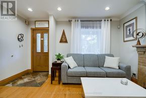 Toronto (Woodbine Corridor) apartment for rent - A living room with a grey couch and a wooden door.