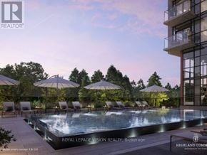 Toronto (Centennial Scarborough) condo for rent - A pool surrounded by chairs and umbrellas in front of a building.