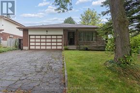 Guelph (Kortright West) apartment for rent - A house with a garage and a driveway in front of it.